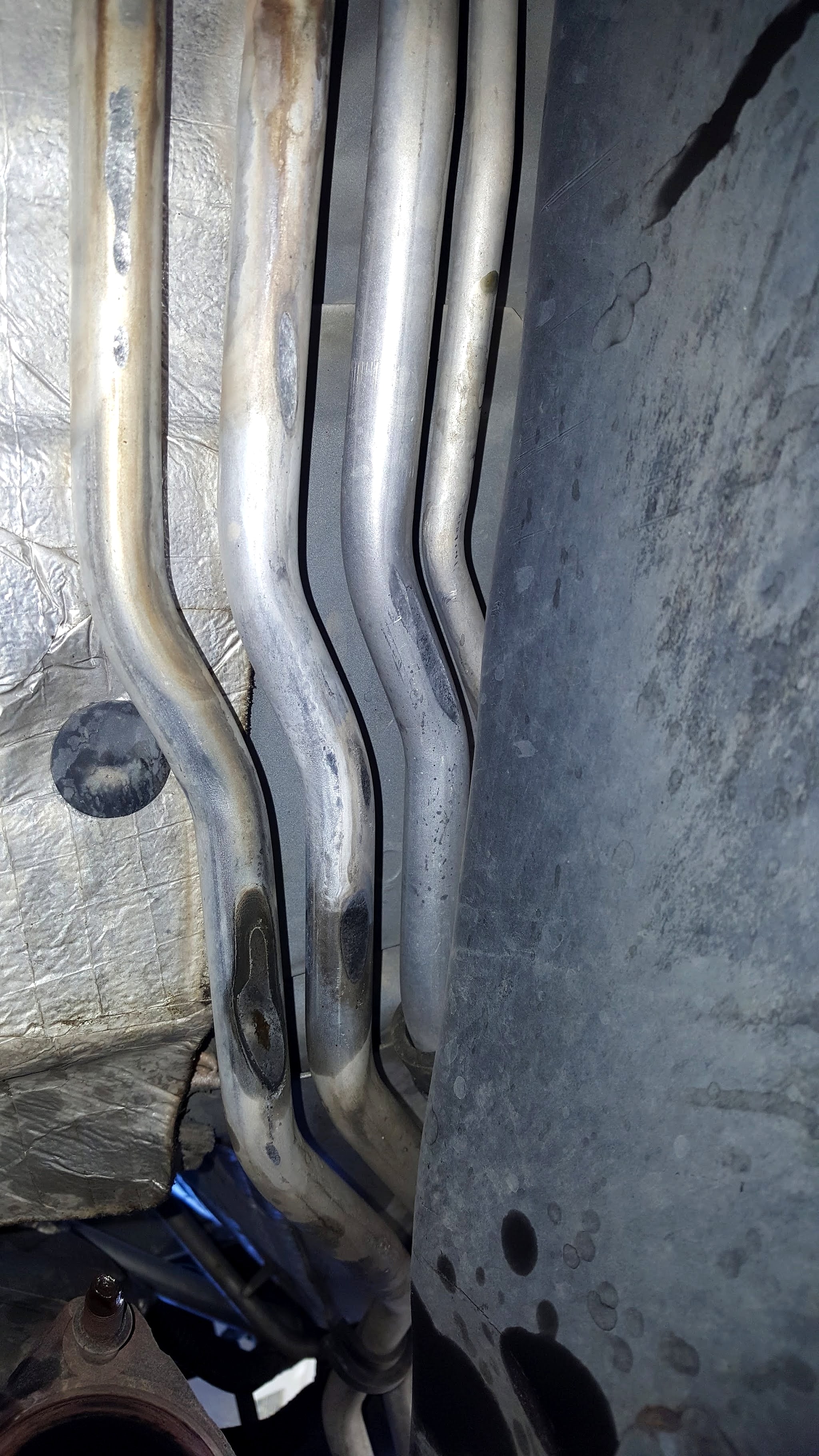 Under the car: exhaust pipes running past the heat shield